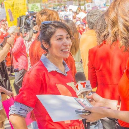 Emiliana is interviewed by a reporter at the Women’s March