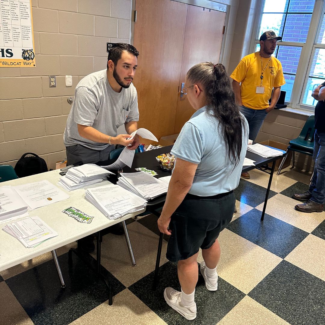 An IUPAT member receiving training materials at an Action Builder training.